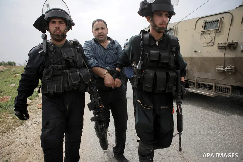 Israeli security forces detain a Palestinian protester during clashes following a protest marking the Palestinian Land Day in the West Bank village of Nabi Saleh near Ramallah, March 28, 2015. Land Day commemorates the u...