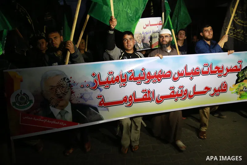Palestinian Hamas supporters hold banners during a rally against the Palestinian President Mahmoud Abbas, in Jabaliya in the northern Gaza Strip, March 29, 2015. Palestinian President Mahmoud Abbas caused a furor before...
