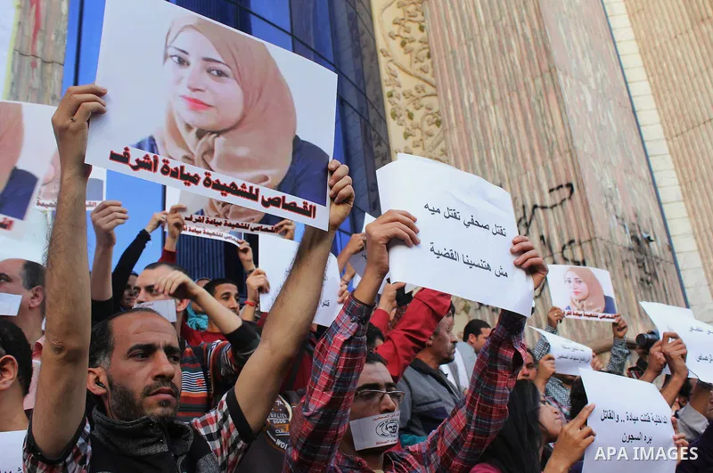 Egyptian Journalists, hold pictures of thier fellow Mayada Ashraf, during the first anniversary of her death by Egyptian police, in front of the Journalists Syndicate, in Cairo on March 30, 2015. Photo by Amr Sayed