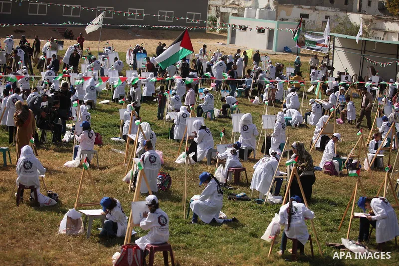 Palestinians artists paint artworks during an activity marking Land Day in Gaza City March 30, 2015. Palestinians mark Land Day on March 30, the annual commemoration of protests in 1976 against Israel's appropriation of...