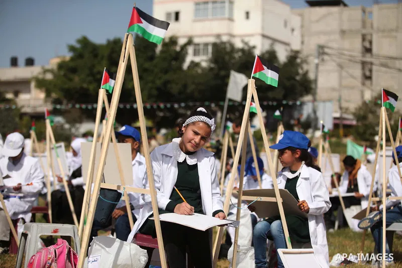 Palestinians artists paint artworks during an activity marking Land Day in Gaza City March 30, 2015. Palestinians mark Land Day on March 30, the annual commemoration of protests in 1976 against Israel's appropriation of...