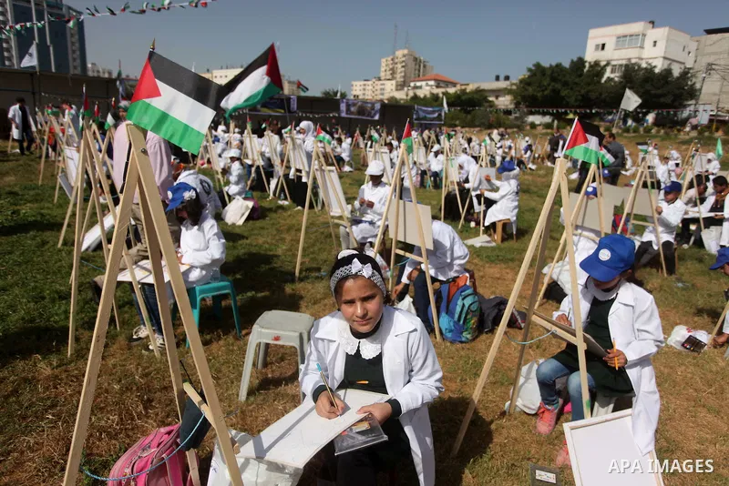Palestinians artists paint artworks during an activity marking Land Day in Gaza City March 30, 2015. Palestinians mark Land Day on March 30, the annual commemoration of protests in 1976 against Israel's appropriation of...