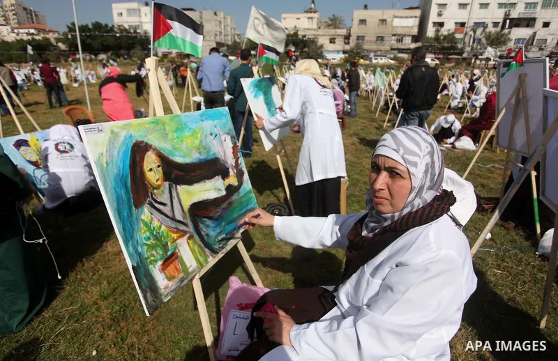 Palestinians artists paint artworks during an activity marking Land Day in Gaza City March 30, 2015. Palestinians mark Land Day on March 30, the annual commemoration of protests in 1976 against Israel's appropriation of...