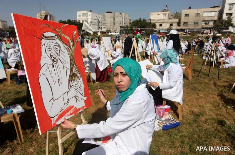 Palestinians artists paint artworks during an activity marking Land Day in Gaza City March 30, 2015. Palestinians mark Land Day on March 30, the annual commemoration of protests in 1976 against Israel's appropriation of...