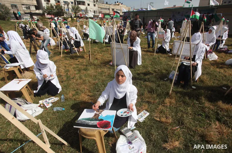 Palestinians artists paint artworks during an activity marking Land Day in Gaza City March 30, 2015. Palestinians mark Land Day on March 30, the annual commemoration of protests in 1976 against Israel's appropriation of...