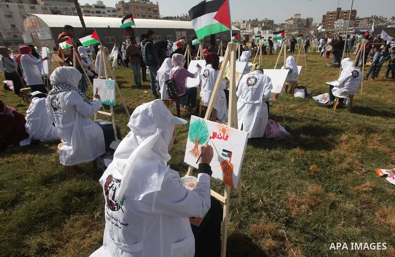Palestinians artists paint artworks during an activity marking Land Day in Gaza City March 30, 2015. Palestinians mark Land Day on March 30, the annual commemoration of protests in 1976 against Israel's appropriation of...