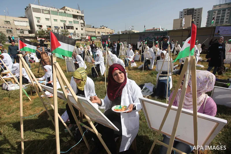 Palestinians artists paint artworks during an activity marking Land Day in Gaza City March 30, 2015. Palestinians mark Land Day on March 30, the annual commemoration of protests in 1976 against Israel's appropriation of...