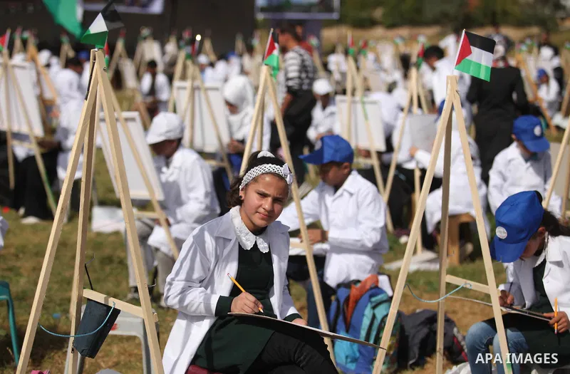 Palestinians artists paint artworks during an activity marking Land Day in Gaza City March 30, 2015. Palestinians mark Land Day on March 30, the annual commemoration of protests in 1976 against Israel's appropriation of...