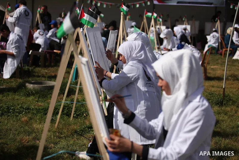 Palestinians artists paint artworks during an activity marking Land Day in Gaza City March 30, 2015. Palestinians mark Land Day on March 30, the annual commemoration of protests in 1976 against Israel's appropriation of...