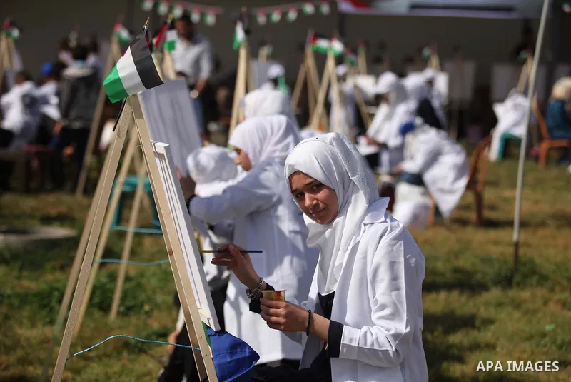 Palestinians artists paint artworks during an activity marking Land Day in Gaza City March 30, 2015. Palestinians mark Land Day on March 30, the annual commemoration of protests in 1976 against Israel's appropriation of...