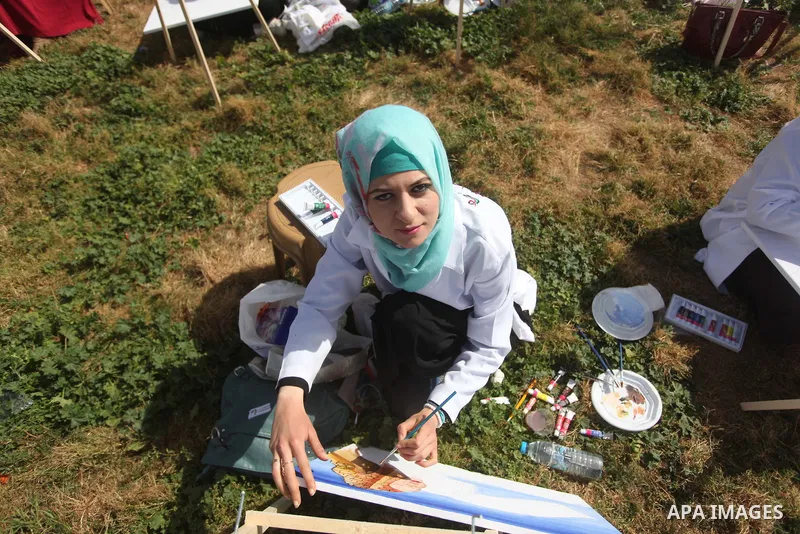 Palestinians artists paint artworks during an activity marking Land Day in Gaza City March 30, 2015. Palestinians mark Land Day on March 30, the annual commemoration of protests in 1976 against Israel's appropriation of...