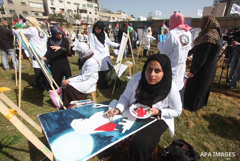 Palestinians artists paint artworks during an activity marking Land Day in Gaza City March 30, 2015. Palestinians mark Land Day on March 30, the annual commemoration of protests in 1976 against Israel's appropriation of...