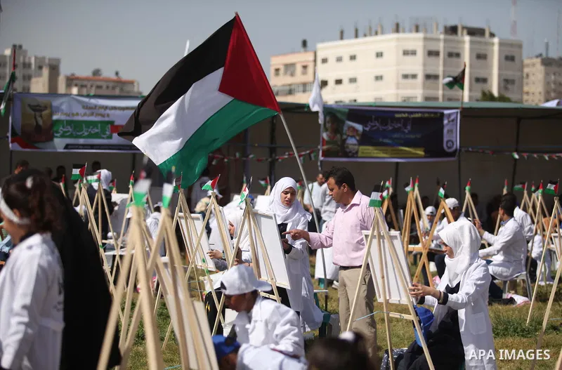 Palestinians artists paint artworks during an activity marking Land Day in Gaza City March 30, 2015. Palestinians mark Land Day on March 30, the annual commemoration of protests in 1976 against Israel's appropriation of...