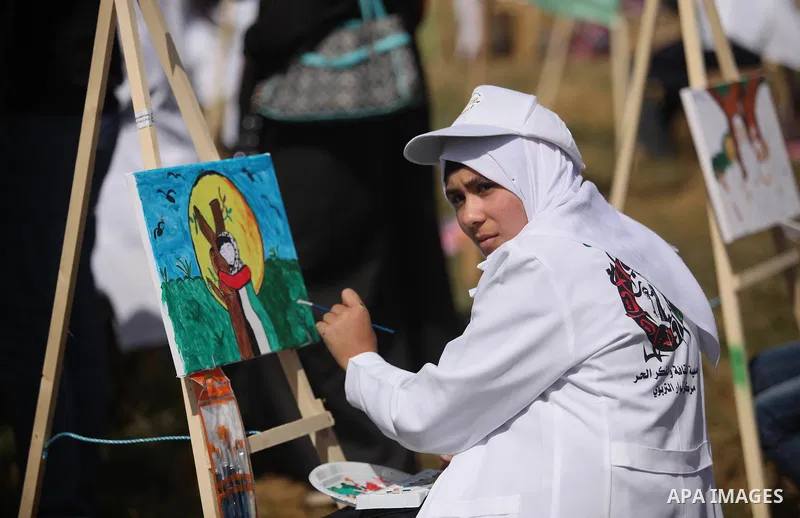 Palestinians artists paint artworks during an activity marking Land Day in Gaza City March 30, 2015. Palestinians mark Land Day on March 30, the annual commemoration of protests in 1976 against Israel's appropriation of...