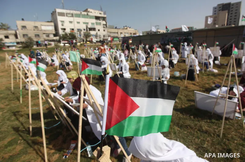 Palestinians artists paint artworks during an activity marking Land Day in Gaza City March 30, 2015. Palestinians mark Land Day on March 30, the annual commemoration of protests in 1976 against Israel's appropriation of...