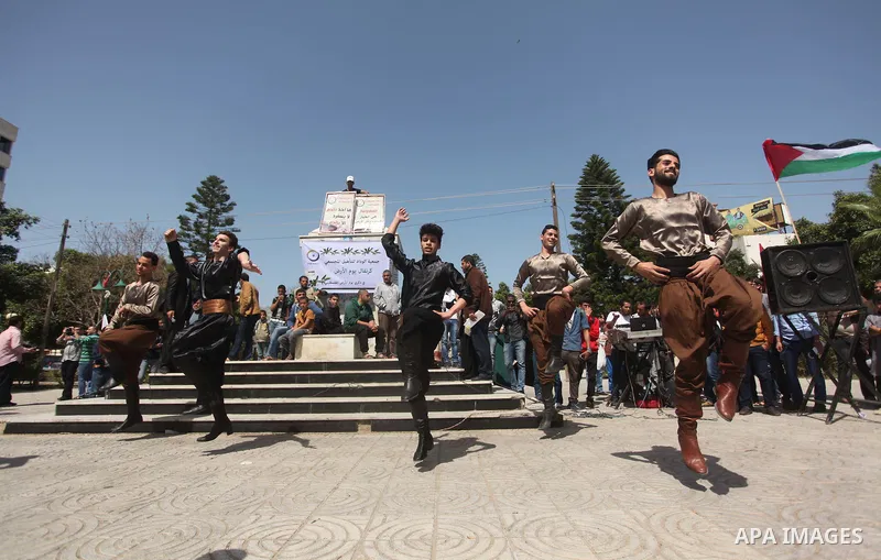 Palestinians youth participate in dancing of "Dabka" during a rally marking Land Day in Gaza City March 30, 2015.The annual demonstrations mark the deaths of six Arab Israeli protesters at the hands of Israeli police and...