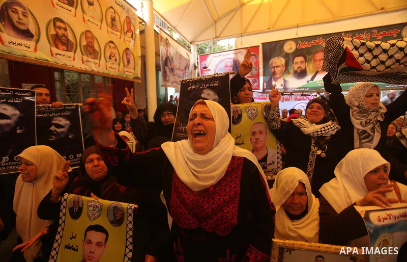 Palestinians take part a protest demanding the release of their relatives prisoners held in Israeli jails, in front of Red cross office, in Gaza city, on March 30, 2015. Photo by Ashraf Amra