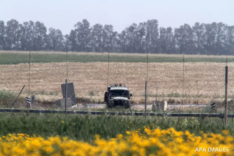 An Israeli military vehicle stands during a rally marking Land day in Absan near the border between Israel and east of the town of Khan Yunis in the southern Gaza Strip March 30, 2015. The annual demonstrations mark the...