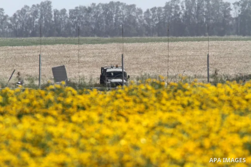 An Israeli military vehicle stands during a rally marking Land day in Absan near the border between Israel and east of the town of Khan Yunis in the southern Gaza Strip March 30, 2015. The annual demonstrations mark the...
