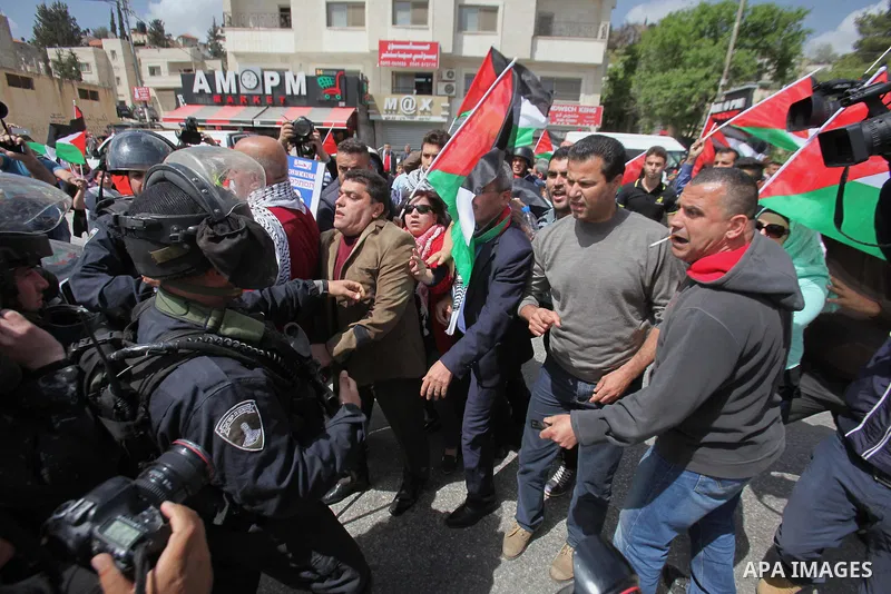 Palestinian protesters argue with an Israeli border policeman during clashes following a protest marking Land Day in the West Bank town of Hawara near Nablus March 30, 2015. Palestinians mark Land Day on March 30, the an...