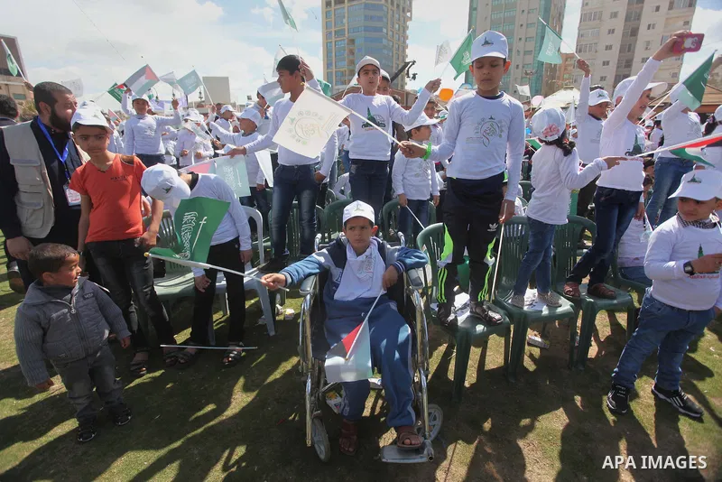 Palestinian orphans attend a ceremony to mark the Orphan Day, in Gaza city, on April 2, 2015. Photo by Ashraf Amra