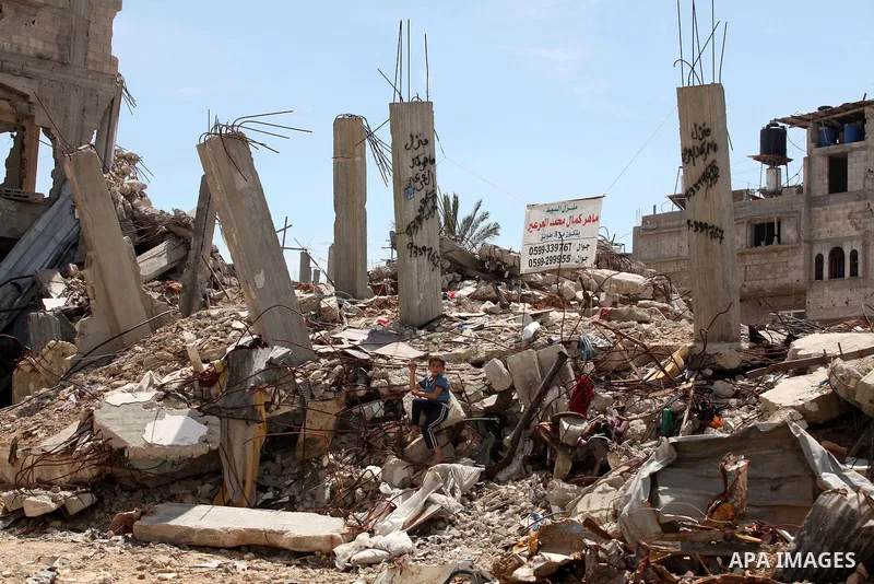 A Palestinian boy sits on the rubble of his family's house that was destroyed during the 50-day Israeli war on Gaza Strip in the summer of 2014, in Gaza City's al-Shejaiya neighbourhood, on April 2, 2015. The Palestinian...