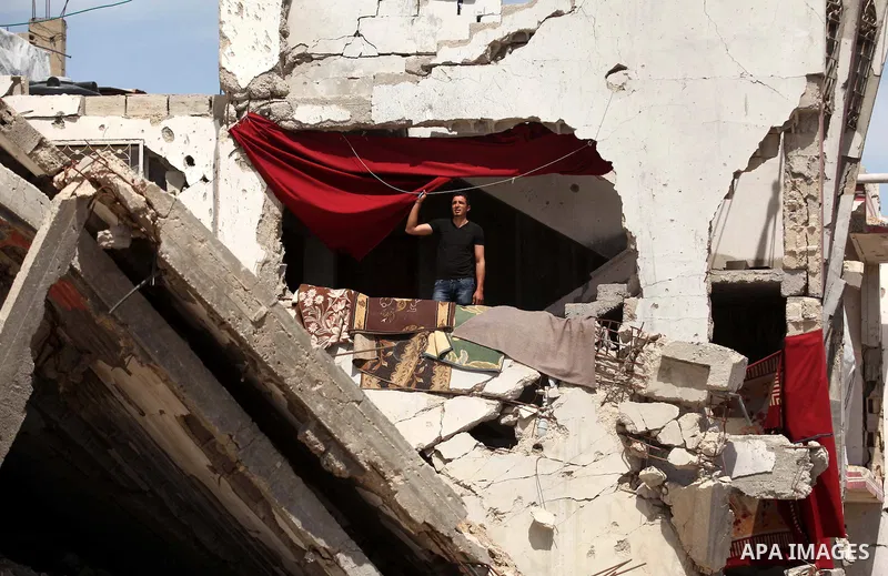 A Palestinian man stands on the rubble of his house that was destroyed during the 50-day Israeli war on Gaza Strip in the summer of 2014, in Gaza City's al-Shejaiya neighbourhood, on April 2, 2015. The Palestinians forma...