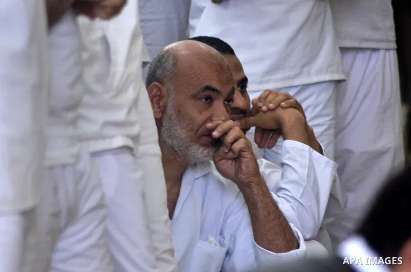 Egyptian defendants in the trial of US embassy violence stand in the court room during their trial in Cairo on April 2, 2015. The Cairo Criminal Court delayed the trial of 23 of members of Muslim Brotherhood accusing in...