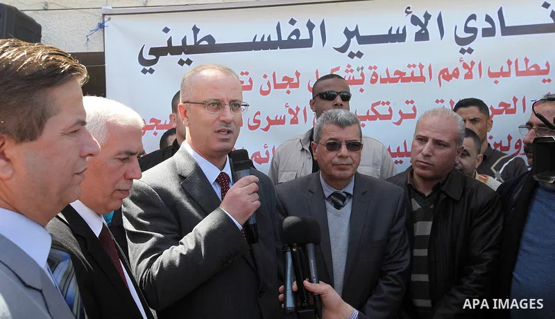 A picture released by the Palestinian Prime Minister office shows Palestinian Prime Minister Rami Hamdallah participating in protest of relatives of Palestinian prisoners in the Israeli jails, outside the Red Cross headq...