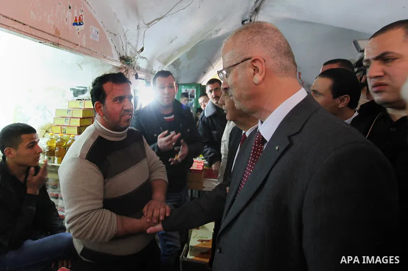 A picture released by the Palestinian Prime Minister office shows Palestinian Prime Minister Rami Hamdallah participating in protest of relatives of Palestinian prisoners in the Israeli jails, outside the Red Cross headq...