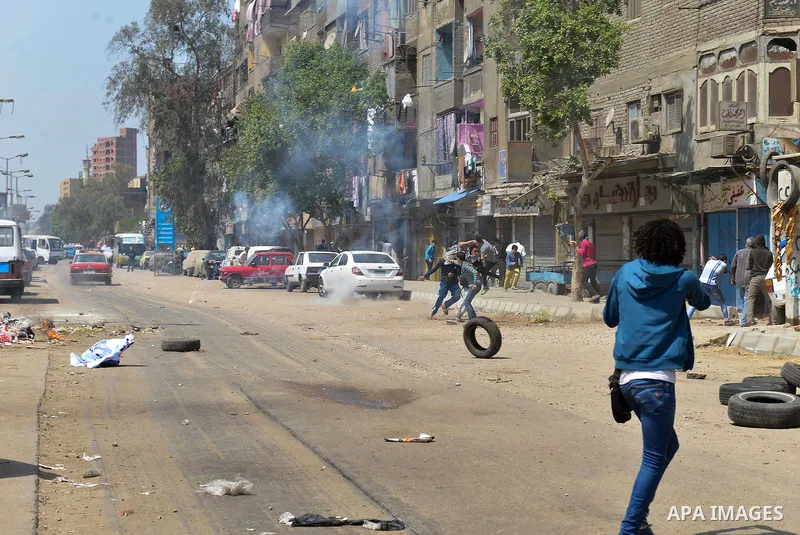 Egyptian supporters of Muslim Brotherhood and ousted president Mohammed Morsi, run for cover from tear gas fired by riot police during clashes in al-Matariya district, near Cairo on April 3, 2015. Photo by Amr Sayed