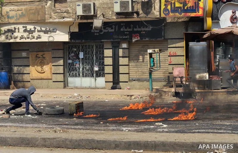 An Egyptian supporter of Muslim Brotherhood and ousted president Mohammed Morsi, burn tyres during clashes with riot police in al-Matariya district, near Cairo on April 3, 2015. Photo by Amr Sayed