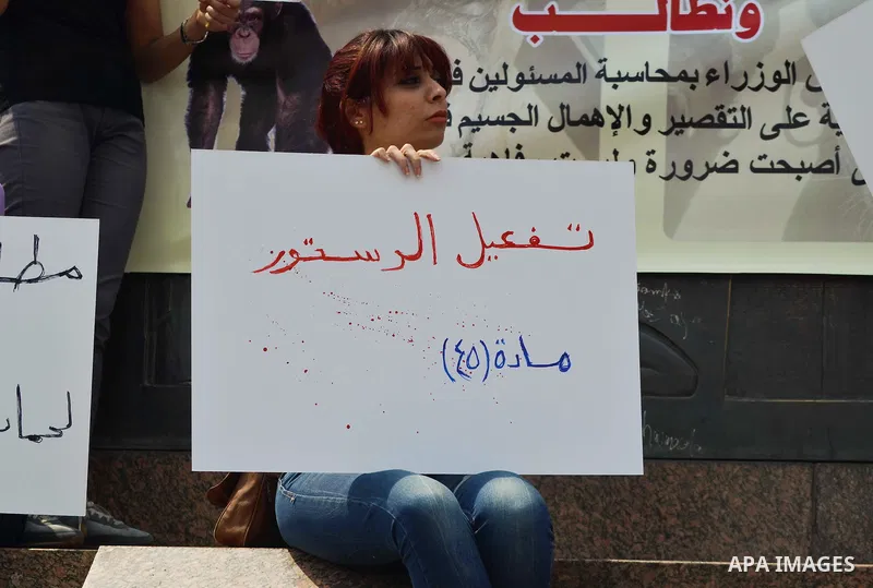 Egyptian women hold banners during a protest demanding animal rights in front of the Opera, Cairo, Egypt on April 4, 2015. Photo by Amr Sayed