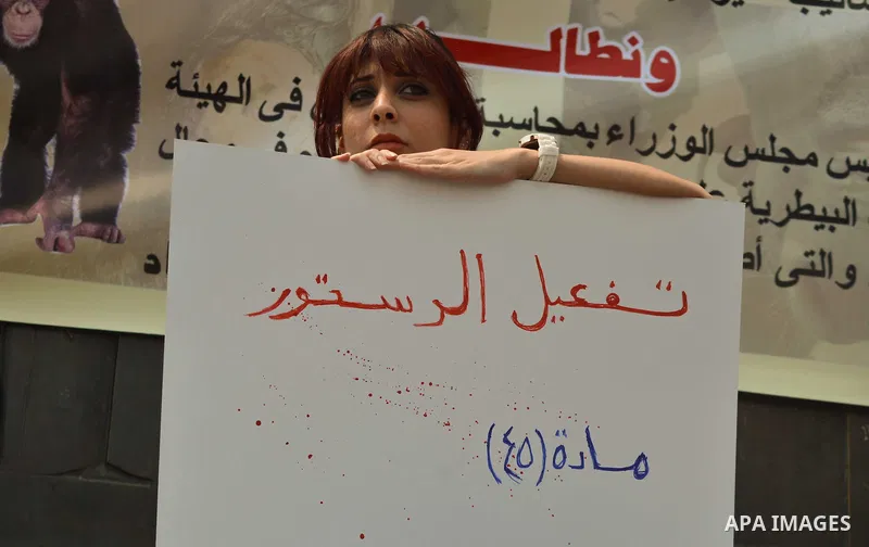 Egyptian women hold banners during a protest demanding animal rights in front of the Opera, Cairo, Egypt on April 4, 2015. Photo by Amr Sayed