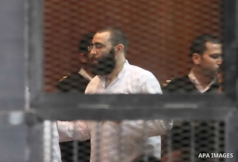Members of Ansar Bayt al-Maqdis stand behind bars at a courtroom, during their trial in Cairo on April 4, 2015. 213 defendant members of Ansar al-Bayt al-Maqdis, including 140 defendants locked up, for committing a crime...