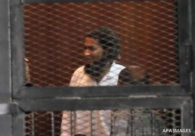 Members of Ansar Bayt al-Maqdis stand behind bars at a courtroom, during their trial in Cairo on April 4, 2015. 213 defendant members of Ansar al-Bayt al-Maqdis, including 140 defendants locked up, for committing a crime...
