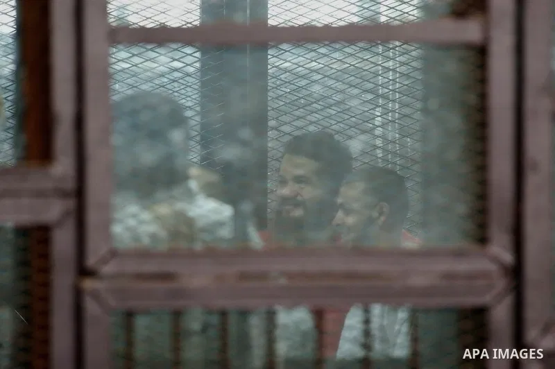 Members of Ansar Bayt al-Maqdis stand behind bars at a courtroom, during their trial in Cairo on April 4, 2015. 213 defendant members of Ansar al-Bayt al-Maqdis, including 140 defendants locked up, for committing a crime...