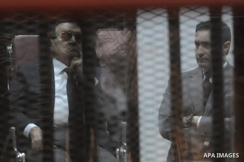 Egypt's former president Hosni Mubarak with his sons are seen inside the court in Cairo, Egypt, on April 4, 2015. An Egyptian court began a retrial on Saturday of former president Hosni Mubarak and his sons for allegedly...