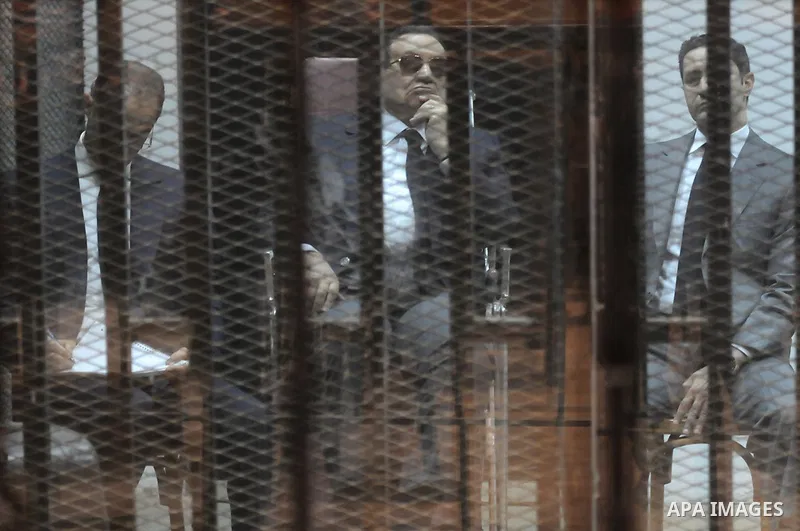 Egypt's former president Hosni Mubarak with his sons are seen inside the court in Cairo, Egypt, on April 4, 2015. An Egyptian court began a retrial on Saturday of former president Hosni Mubarak and his sons for allegedly...