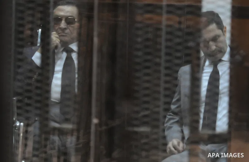 Egypt's former president Hosni Mubarak with his sons are seen inside the court in Cairo, Egypt, on April 4, 2015. An Egyptian court began a retrial on Saturday of former president Hosni Mubarak and his sons for allegedly...