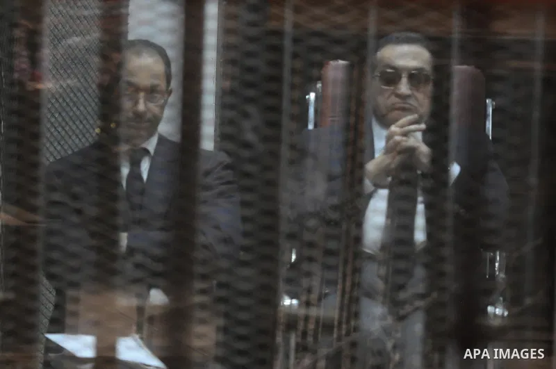Egypt's former president Hosni Mubarak with his sons are seen inside the court in Cairo, Egypt, on April 4, 2015. An Egyptian court began a retrial on Saturday of former president Hosni Mubarak and his sons for allegedly...