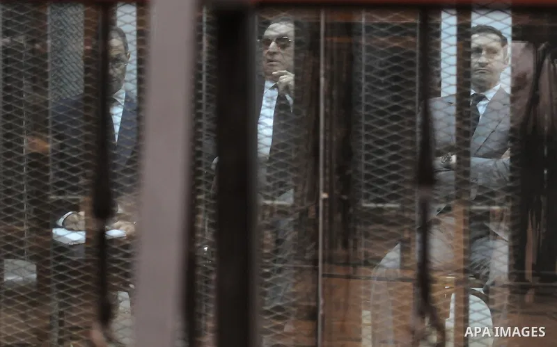 Egypt's former president Hosni Mubarak with his sons are seen inside the court in Cairo, Egypt, on April 4, 2015. An Egyptian court began a retrial on Saturday of former president Hosni Mubarak and his sons for allegedly...