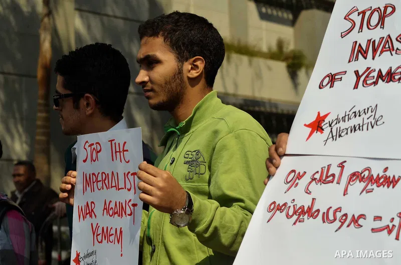 Egyptian protesters hold a placard during a demonstration against airstrikes carried out by the Saudi-led Arab coalition against Huthi militia in front of the Saudi Embassy, cairo, Egypt, on April 4, 2015. Photo by Amr S...
