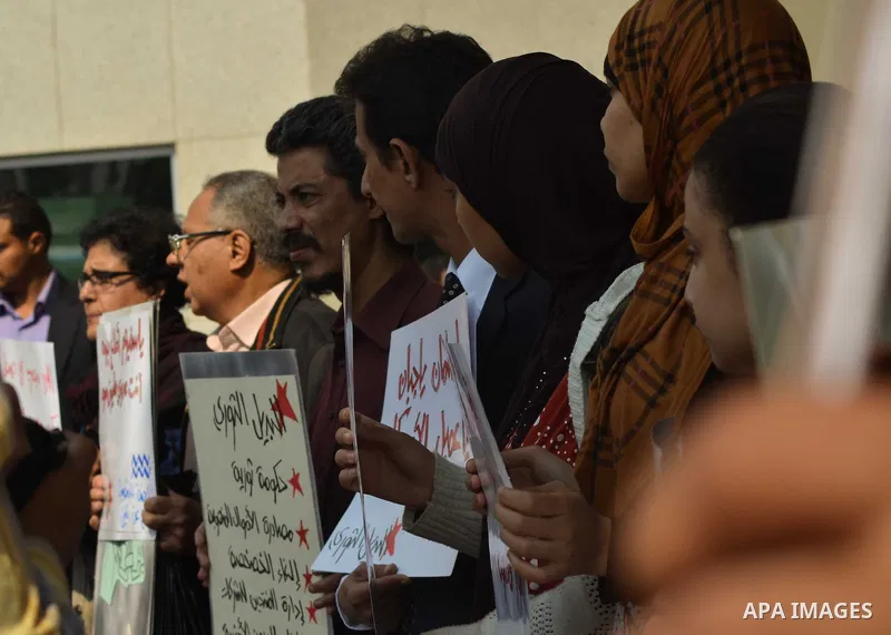 Egyptian protesters hold a placard during a demonstration against airstrikes carried out by the Saudi-led Arab coalition against Huthi militia in front of the Saudi Embassy, cairo, Egypt, on April 4, 2015. Photo by Amr S...