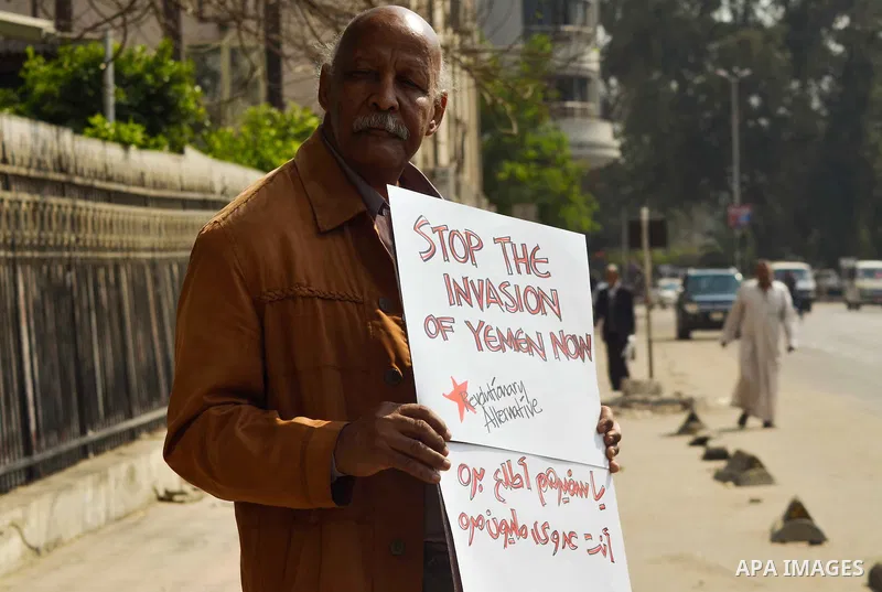Egyptian protesters hold a placard during a demonstration against airstrikes carried out by the Saudi-led Arab coalition against Huthi militia in front of the Saudi Embassy, cairo, Egypt, on April 4, 2015. Photo by Amr S...