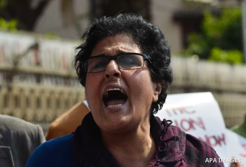 Egyptian protesters hold a placard during a demonstration against airstrikes carried out by the Saudi-led Arab coalition against Huthi militia in front of the Saudi Embassy, cairo, Egypt, on April 4, 2015. Photo by Amr S...