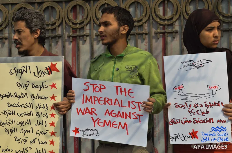 Egyptian protesters hold a placard during a demonstration against airstrikes carried out by the Saudi-led Arab coalition against Huthi militia in front of the Saudi Embassy, cairo, Egypt, on April 4, 2015. Photo by Amr S...