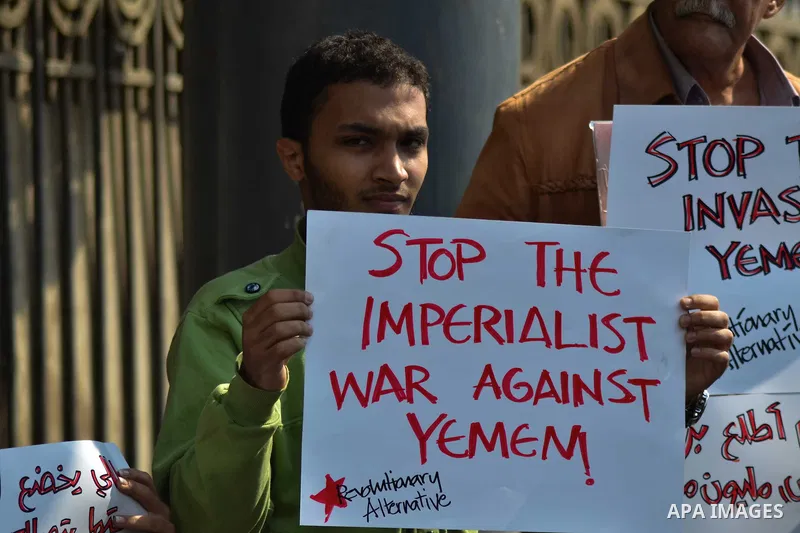 Egyptian protesters hold a placard during a demonstration against airstrikes carried out by the Saudi-led Arab coalition against Huthi militia in front of the Saudi Embassy, cairo, Egypt, on April 4, 2015. Photo by Amr S...