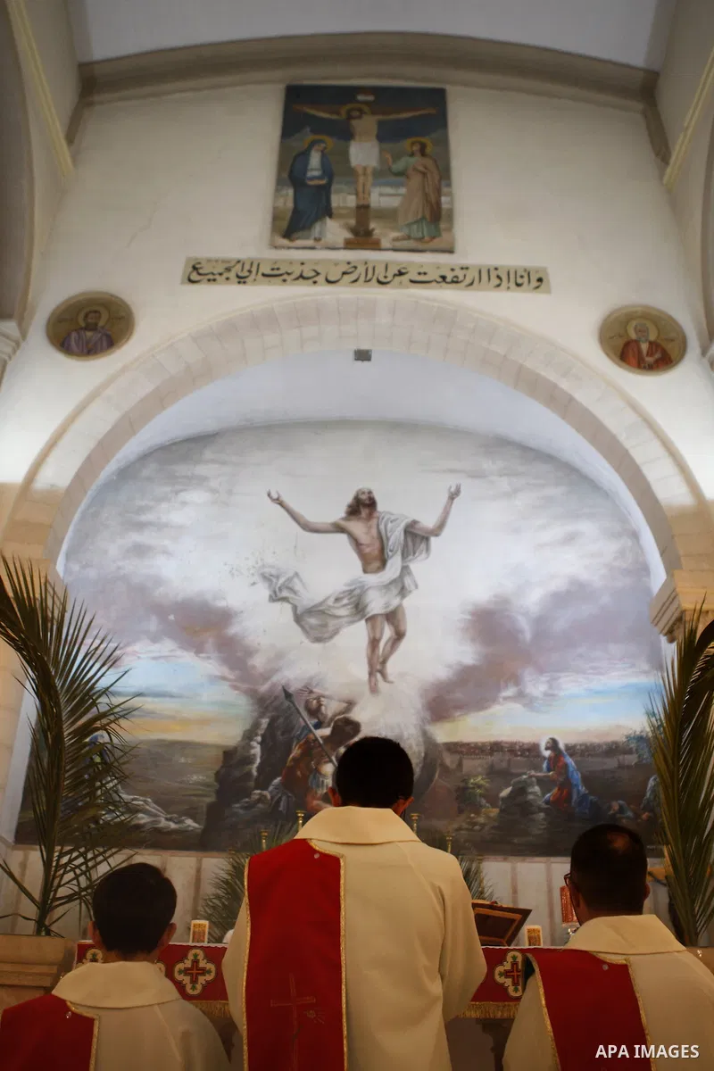 Palestinian Orthodox Christians attend the Palm Sunday mass at Latin Church in the West Bank city of Ramallah on April 5, 2015. Palm Sunday in many Christian churches symbolically marks the biblical account of the entry...