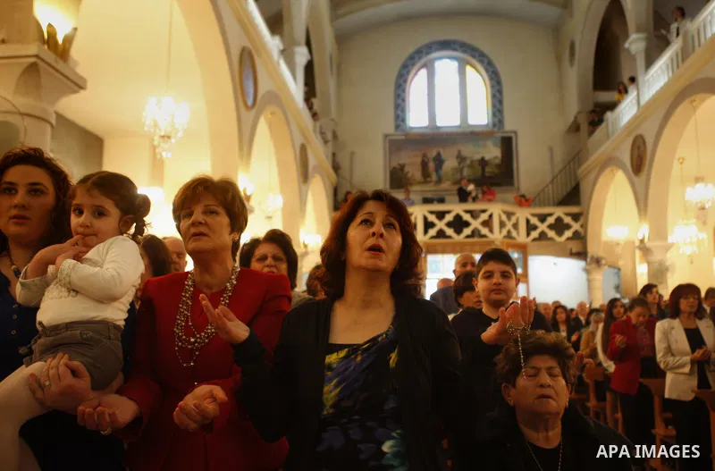 Palestinian Orthodox Christians attend the Palm Sunday mass at Latin Church in the West Bank city of Ramallah on April 5, 2015. Palm Sunday in many Christian churches symbolically marks the biblical account of the entry...